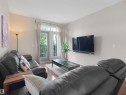 Wood-finish flooring throughout - #89 603 Watt Bv Sw, Edmonton, AB  - Indoor Photo Showing Living Room 