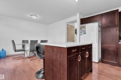 Kitchen island featuring a white countertop and dark wood-finish cabinetry - 