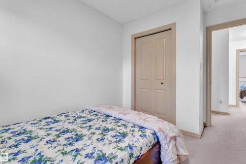 White walls with light-toned trim framing a bi-fold closet door - 7223 19A Avenue Sw, Edmonton, AB - Indoor Photo Showing Bedroom