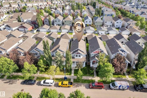 Residential property featuring a light-colored exterior with a prominent bay window and an attached front porch - 7223 19A Avenue Sw, Edmonton, AB - Outdoor With View