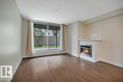 #122 17011 67 Av Nw, Edmonton, AB - Indoor Photo Showing Living Room With Fireplace