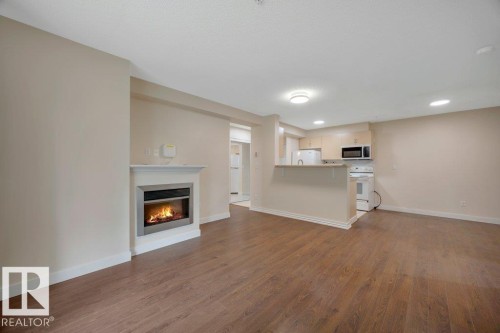#122 17011 67 Av Nw, Edmonton, AB - Indoor Photo Showing Other Room With Fireplace