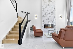 Hardwood staircase with integrated lighting and glass panel railing - 