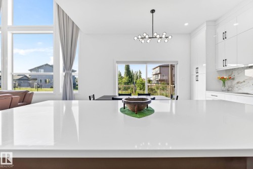Spacious kitchen island with a white polished countertop - 3926 41 Avenue, Beaumont, AB - Indoor
