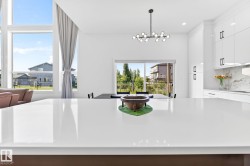 Spacious kitchen island with a white polished countertop - 
