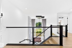 Open concept upper landing featuring light wood-finish flooring - 