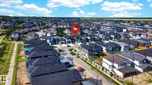 Aerial perspective of a developed residential neighborhood with structured streets, sidewalks, and green spaces - 3926 41 Avenue, Beaumont, AB - Outdoor With View