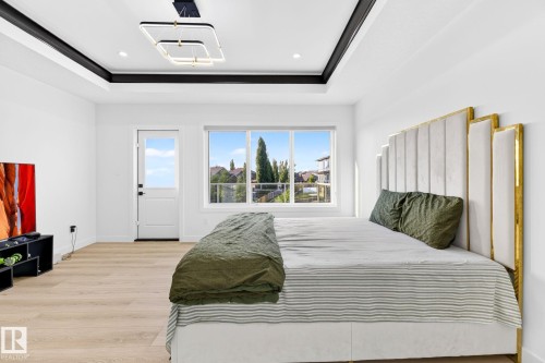 Recessed ceiling details with integrated lighting and a contemporary ceiling fixture - 3926 41 Avenue, Beaumont, AB - Indoor Photo Showing Bedroom