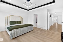Light wood-finish flooring complements the white walls and trim - 