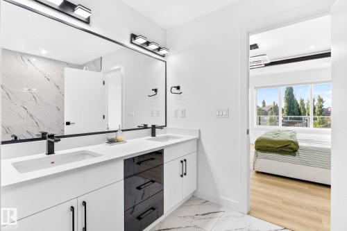 Dual vanity featuring undermount sinks, matte black fixtures, and a white countertop - 3926 41 Avenue, Beaumont, AB - Indoor Photo Showing Bathroom