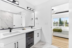 Dual vanity featuring undermount sinks, matte black fixtures, and a white countertop - 