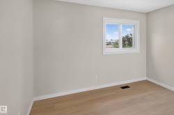 Light wood-finish flooring, neutral wall paint, and white trim - 