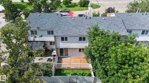 Rear exterior featuring a multi-level wood deck, white railing, and a section of green artificial turf - 175 Centennial Crest Nw, Edmonton, AB - Outdoor