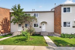 Siding exterior with brick accents, concrete walkways, and mature landscaping - 