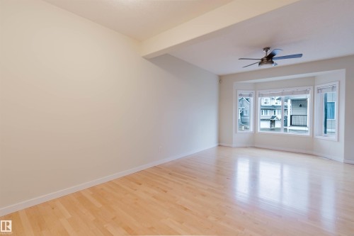 Hardwood flooring, bay window, ceiling fan, and recessed lighting - #2 13215 153 Av Nw, Edmonton, AB - Indoor Photo Showing Other Room