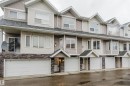 Multi-level exterior with light-toned siding and stone veneer accents - #2 13215 153 Av Nw, Edmonton, AB  - Outdoor With Facade 