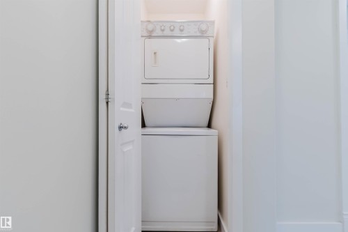 White stackable washer and dryer unit - #2 13215 153 Av Nw, Edmonton, AB - Indoor Photo Showing Laundry Room