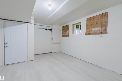 Light wood-finish flooring, recessed lighting, and white walls - #2 13215 153 Av Nw, Edmonton, AB - Indoor Photo Showing Other Room