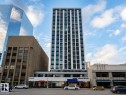 Modern high-rise building with a sleek white and dark facade - #1002 10024 Jasper Av Nw, Edmonton, AB  - Outdoor With Facade 
