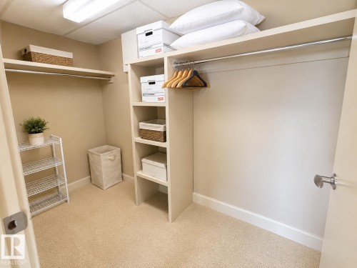 Built-in closet system featuring shelving and hanging rods - #1201 10035 Saskatchewan Dr Nw, Edmonton, AB - Indoor