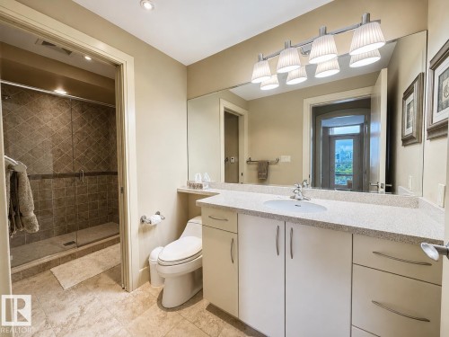 Vanity with a single basin sink, white cabinetry, and light-toned countertop - #1201 10035 Saskatchewan Dr Nw, Edmonton, AB - Indoor Photo Showing Bathroom