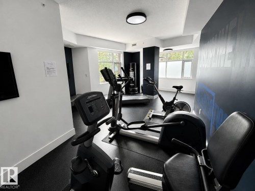 Fitness center featuring recessed lighting, a window, and durable flooring - #1201 10035 Saskatchewan Dr Nw, Edmonton, AB - Indoor Photo Showing Gym Room