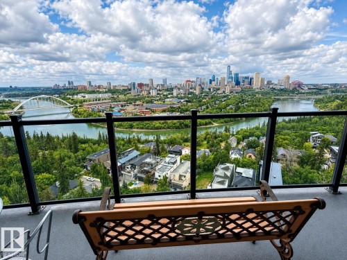 Expansive cityscape, river, and bridge scenery from a balcony with a glass railing and dark metal balusters - #1201 10035 Saskatchewan Dr Nw, Edmonton, AB - Outdoor With Body Of Water With Balcony With View