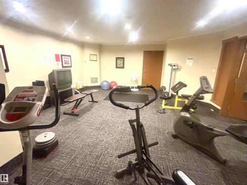 Dedicated fitness room featuring recessed lighting, a neutral wall color, and patterned carpeting - #202 8802 Southfort Dr, Fort Saskatchewan, AB - Indoor Photo Showing Gym Room