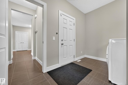 Light-colored walls, tile flooring, white interior doors, and white trim - 1323 158 Street Sw, Edmonton, AB - Indoor Photo Showing Other Room