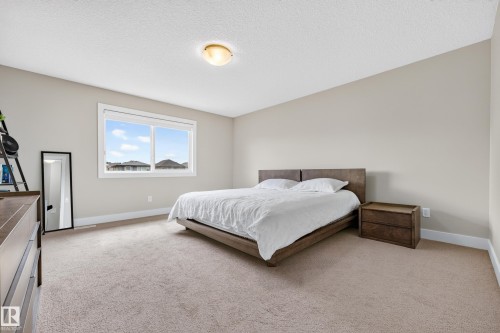 Carpeted flooring with light-toned walls and trim - 1323 158 Street Sw, Edmonton, AB - Indoor Photo Showing Bedroom