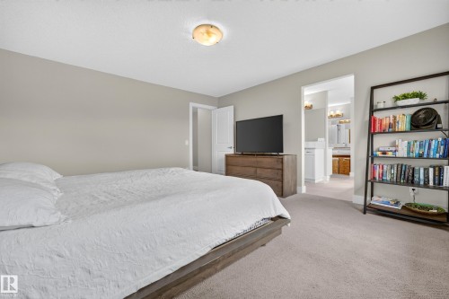 Neutral wall tones, carpet flooring, and a ceiling-mounted light fixture - 1323 158 Street Sw, Edmonton, AB - Indoor Photo Showing Bedroom