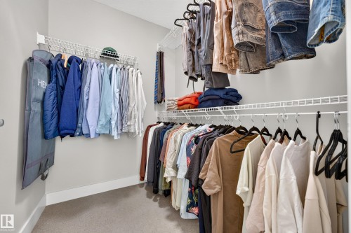 Walk-in closet featuring wire shelving, multiple hanging rods, and light gray wall paint - 1323 158 Street Sw, Edmonton, AB - Indoor With Storage