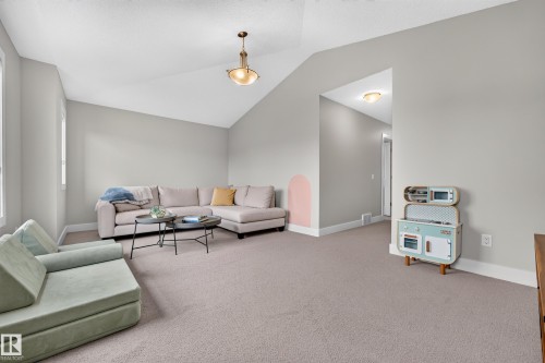 Vaulted ceiling with an overhead light fixture, light gray walls, and light-colored carpeting - 1323 158 Street Sw, Edmonton, AB - Indoor