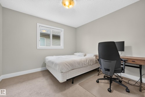 Light-colored carpeting, neutral wall paint, and a built-in window with white trim - 1323 158 Street Sw, Edmonton, AB - Indoor Photo Showing Bedroom