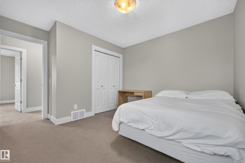 Neutral-toned walls, textured ceiling, and plush carpeting - 1323 158 Street Sw, Edmonton, AB - Indoor Photo Showing Bedroom