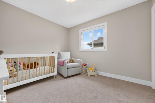 Wall-to-wall carpeting with light-toned walls and a single window with white trim - 1323 158 Street Sw, Edmonton, AB - Indoor Photo Showing Bedroom