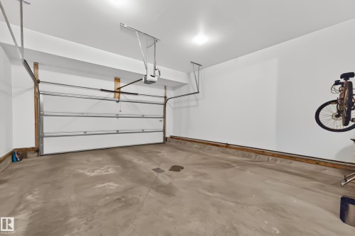 Concrete flooring, white walls, and an automatic garage door opener - 1323 158 Street Sw, Edmonton, AB - Indoor Photo Showing Garage