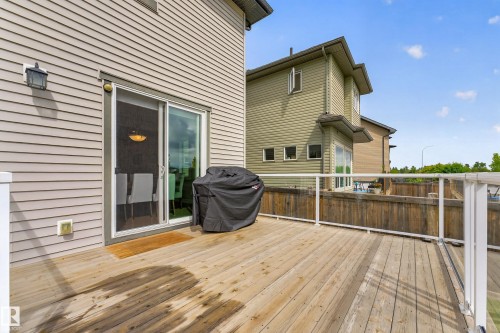 Expansive wood deck with clear panel railings, offering direct access to the interior via a sliding glass door - 1323 158 Street Sw, Edmonton, AB - Outdoor With Deck Patio Veranda With Exterior