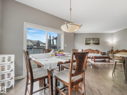 Hardwood-finish flooring throughout, vaulted ceiling, large picture window, and recessed lighting - 1478 37B Avenue Nw, Edmonton, AB - Indoor Photo Showing Dining Room