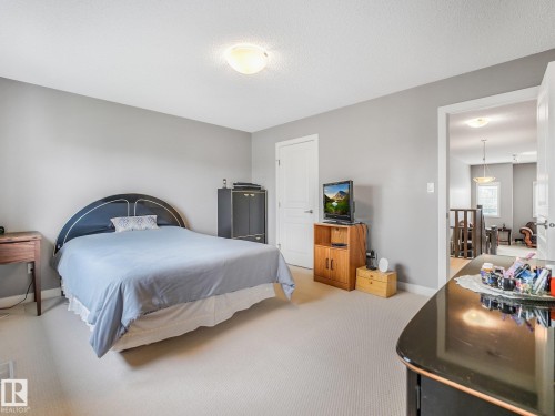 Neutral wall color, carpeted flooring, and a flush mount ceiling light fixture - 1478 37B Avenue Nw, Edmonton, AB - Indoor Photo Showing Bedroom