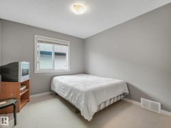 Window with blinds and white trim, light gray painted walls, and light-toned carpet flooring - 