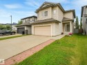 Two-story exterior with light-colored siding, a covered front entry, and an attached two-car garage - 1478 37B Avenue Nw, Edmonton, AB  - Outdoor 