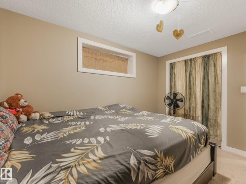 Recessed window with white trim, built-in ceiling light fixture, and neutral painted walls - 1478 37B Avenue Nw, Edmonton, AB - Indoor Photo Showing Bedroom