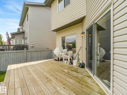Spacious wood deck with a privacy fence and exterior wall lantern - 1478 37B Avenue Nw, Edmonton, AB - Outdoor With Deck Patio Veranda With Exterior