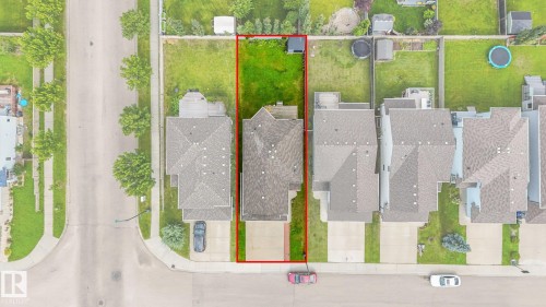 Property featuring a residential structure, a paved driveway, and a grassed yard space - 1478 37B Avenue Nw, Edmonton, AB - 