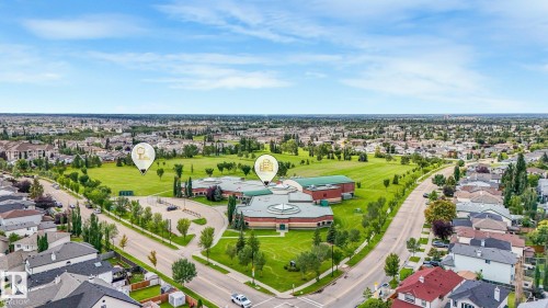 Expansive neighborhood featuring mature trees, residential properties, and a dedicated park area - 1478 37B Avenue Nw, Edmonton, AB - Outdoor With View