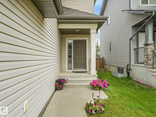 Covered entryway featuring a solid-panel door with decorative glass inserts - 1478 37B Avenue Nw, Edmonton, AB - Outdoor With Exterior