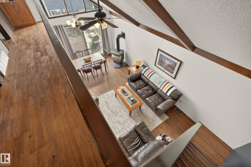 Wood-finish flooring throughout, exposed ceiling beams, and a ceiling fan with integrated lighting - 264 Beach Avenue, Rural Barrhead County, AB - Indoor Photo Showing Other Room
