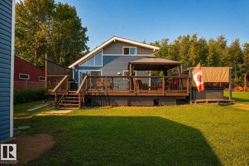 Expansive rear deck with a gazebo, full privacy screening, and built-in hot tub - 264 Beach Avenue, Rural Barrhead County, AB - Outdoor With Deck Patio Veranda