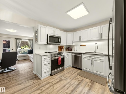 #211 9003 106A Av Nw, Edmonton, AB - Indoor Photo Showing Kitchen With Stainless Steel Kitchen